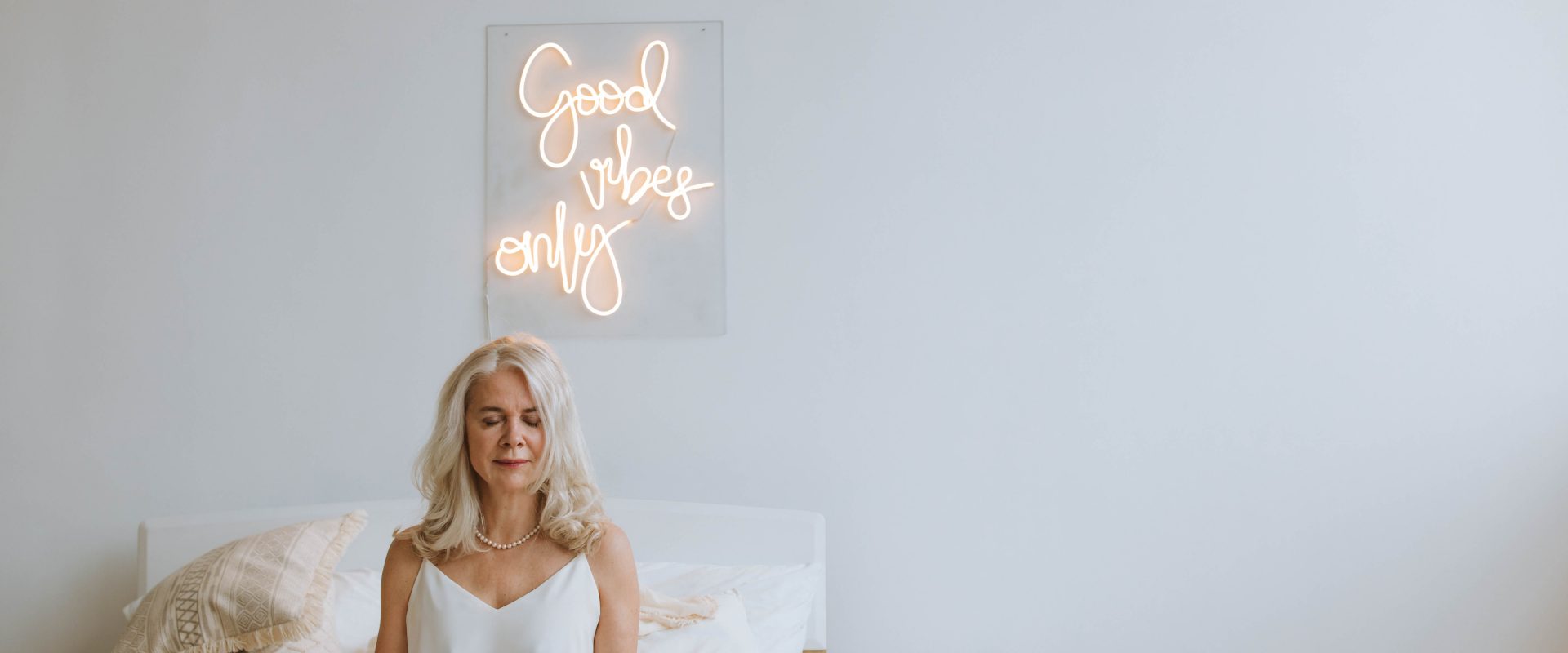 a woman meditating on her bed