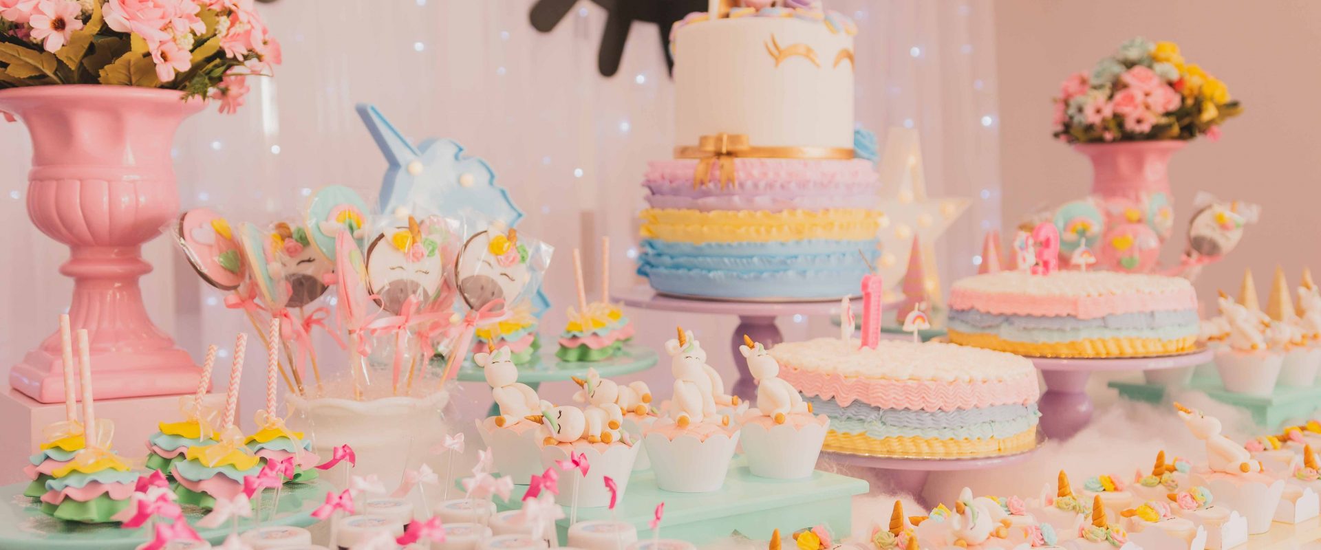 a table with many different, colourful cakes