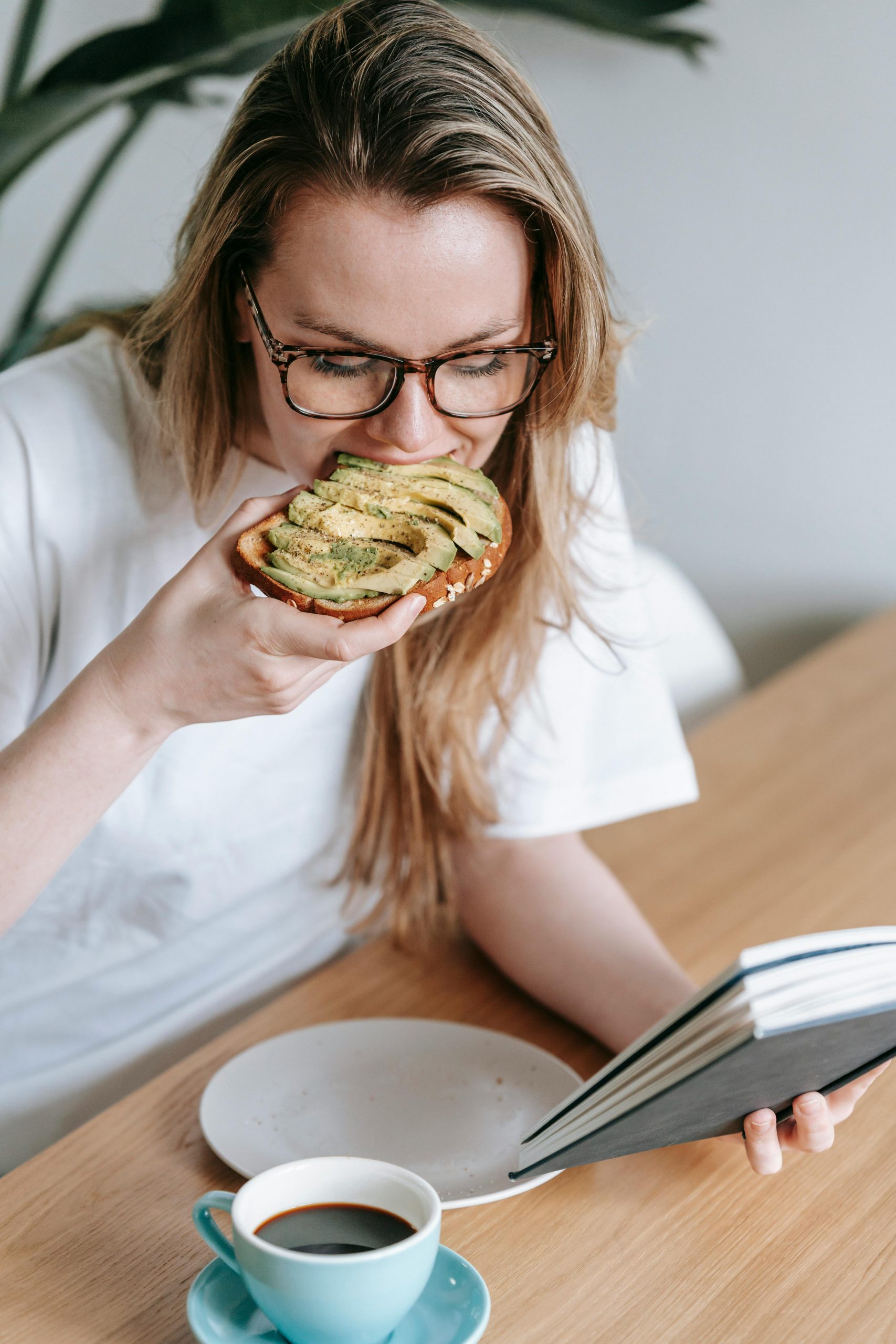 woman eating avo on toast